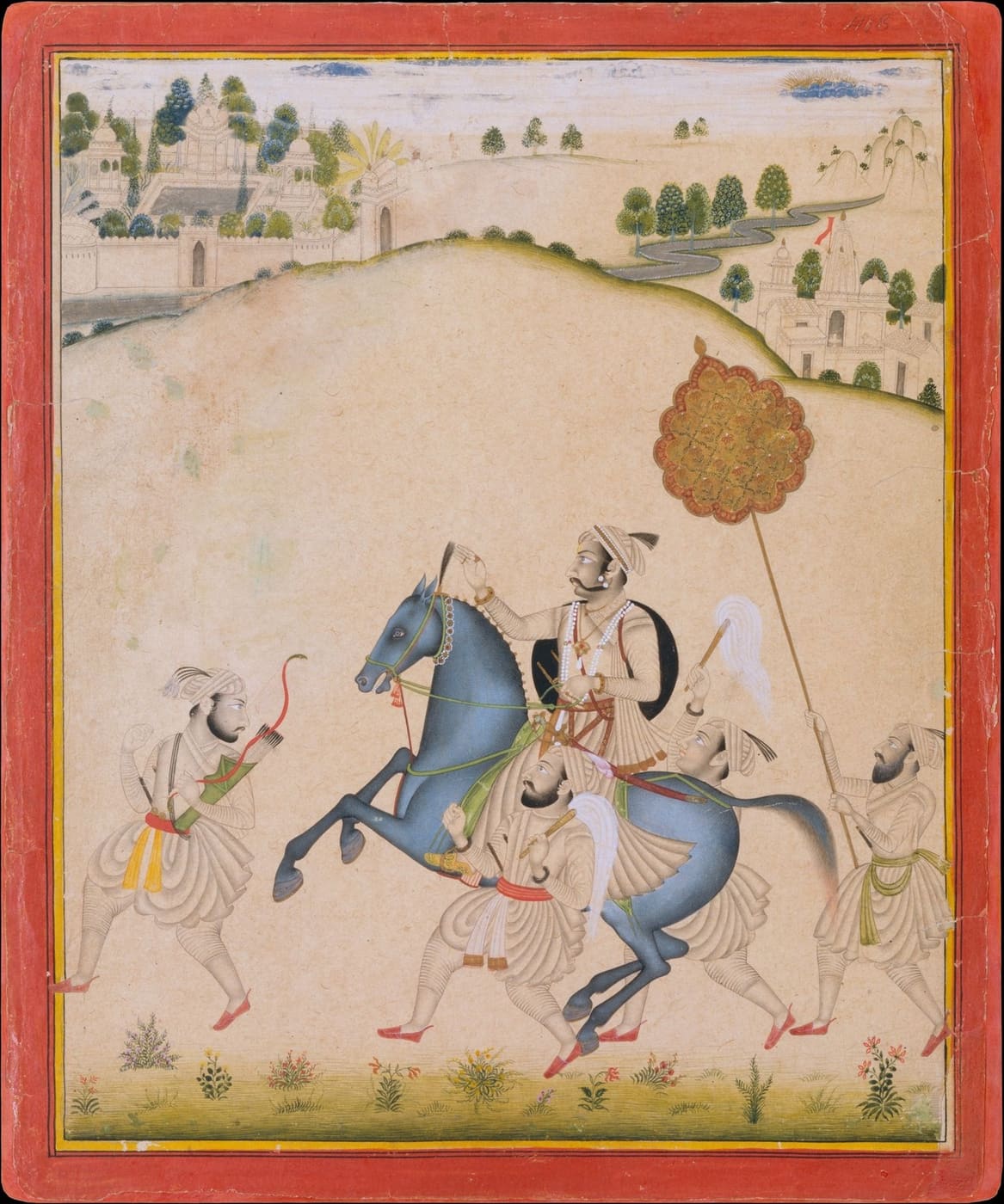 A maharana rides a blue-grey horse across the hills with attendants