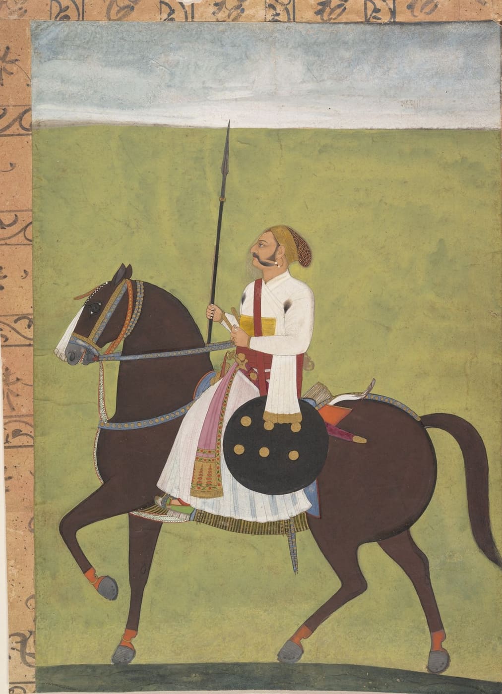 A Rajput nobleman on a dark horse with a shield and lance