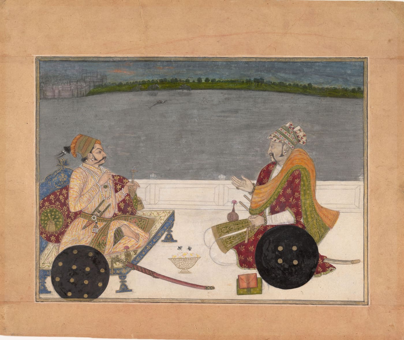 A prince and his bard sit on a palace terrace above a lake